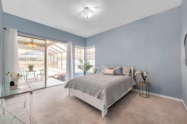carpeted bedroom with baseboards and access to exterior