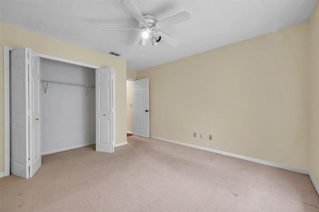 unfurnished bedroom featuring ceiling fan, visible vents, carpet floors, baseboards, and a closet