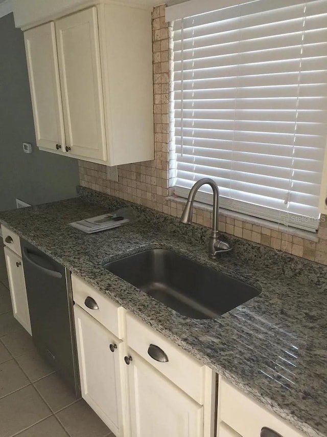 3115 Winchester Dr, Dunedin, FL 34698 - kitchen with a sink, tile patterned flooring, tasteful backsplash, and light stone countertops