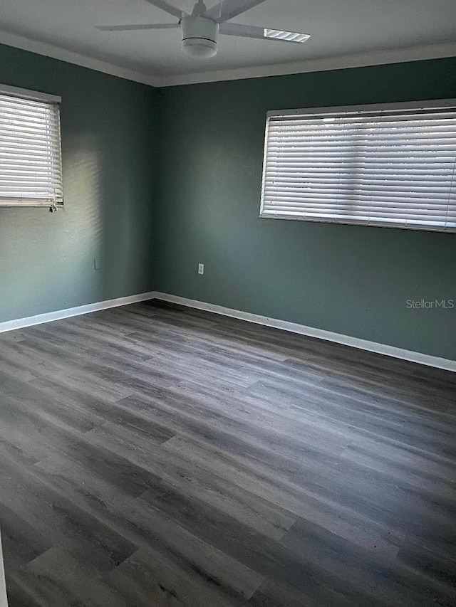 3115 Winchester Dr, Dunedin, FL 34698 - unfurnished room with baseboards, ornamental molding, dark wood finished floors, and a ceiling fan