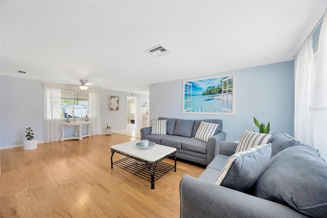 living area featuring ceiling fan, visible vents, and light wood-style floors