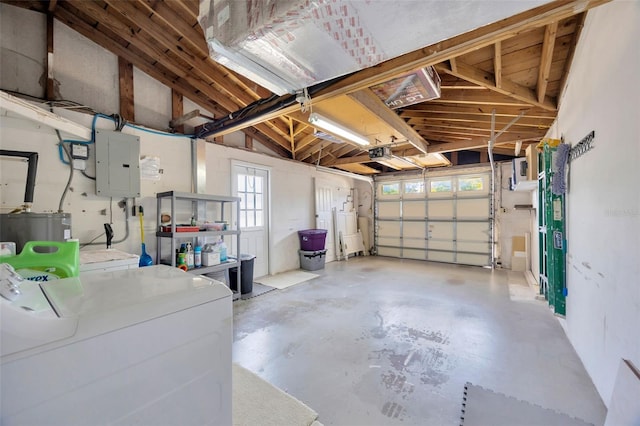 garage featuring separate washer and dryer, a garage door opener, electric panel, and electric water heater