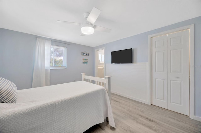 bedroom featuring baseboards, ceiling fan, and light wood-style flooring