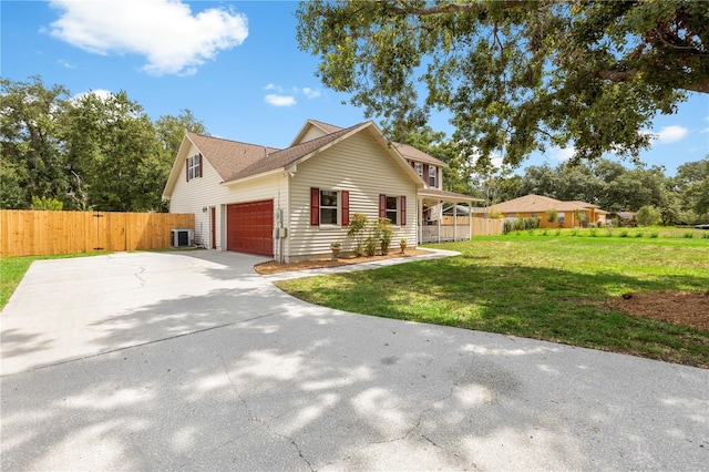 2512 Rustic Oaks Dr, Lutz, FL 33559 - view of front facade featuring concrete driveway, central AC unit, and an attached garage