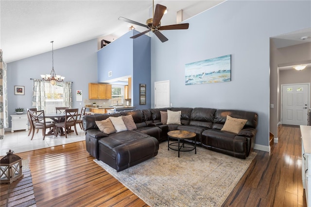 2512 Rustic Oaks Dr, Lutz, FL 33559 - living room with ceiling fan, high vaulted ceiling, a chandelier, and wood finished floors