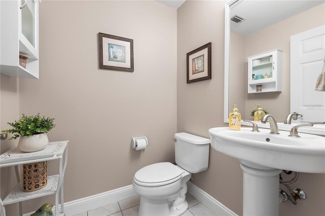 2512 Rustic Oaks Dr, Lutz, FL 33559 - half bathroom with toilet, baseboards, and tile patterned floors