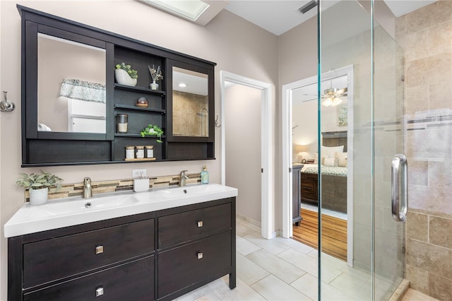 2512 Rustic Oaks Dr, Lutz, FL 33559 - ensuite bathroom featuring double vanity, a stall shower, tile patterned flooring, and a ceiling fan