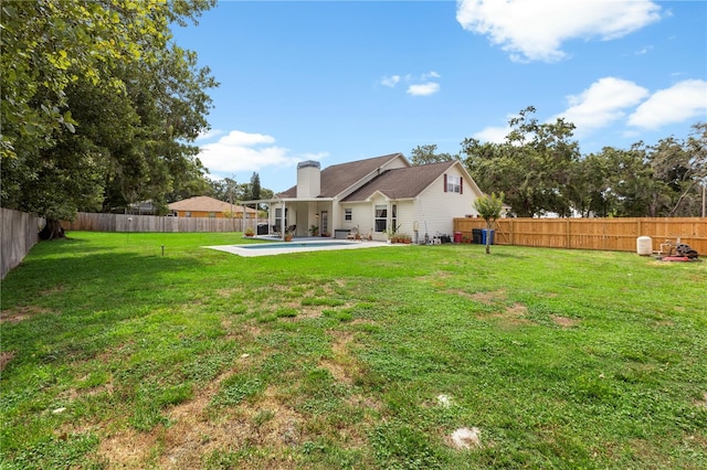 2512 Rustic Oaks Dr, Lutz, FL 33559 - rear view of property featuring a patio area and a chimney