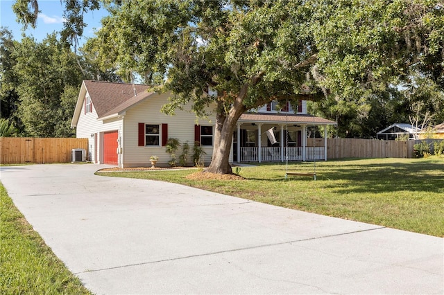 2512 Rustic Oaks Dr, Lutz, FL 33559 - view of front facade with a porch, central AC, and driveway