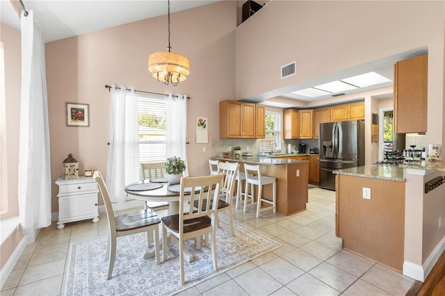 2512 Rustic Oaks Dr, Lutz, FL 33559 - dining area with a chandelier, baseboards, plenty of natural light, and a towering ceiling
