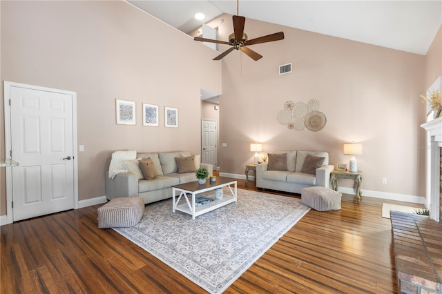 2512 Rustic Oaks Dr, Lutz, FL 33559 - living room featuring a ceiling fan, high vaulted ceiling, wood finished floors, baseboards, and a brick fireplace