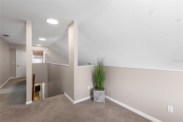 2512 Rustic Oaks Dr, Lutz, FL 33559 - corridor featuring an upstairs landing, carpet, baseboards, and lofted ceiling