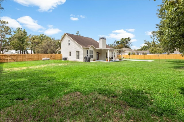 2512 Rustic Oaks Dr, Lutz, FL 33559 - rear view of house featuring a chimney, a patio area, and central AC unit
