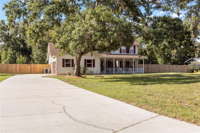 2512 Rustic Oaks Dr, Lutz, FL 33559 - view of front of house with a porch, driveway, and cooling unit