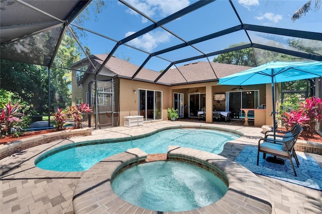 view of swimming pool with a lanai, ceiling fan, a patio area, and a pool with connected hot tub