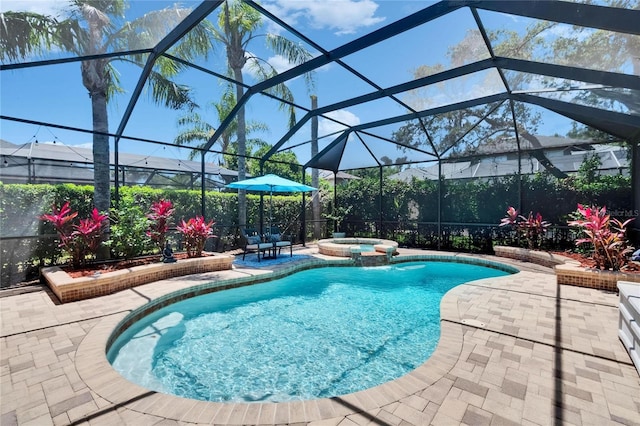 view of pool featuring glass enclosure, a patio area, and a pool with connected hot tub