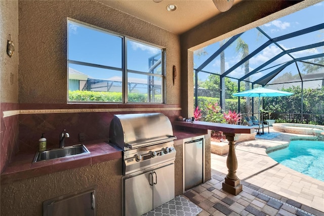 exterior space featuring area for grilling, an in ground hot tub, exterior kitchen, a sink, and glass enclosure