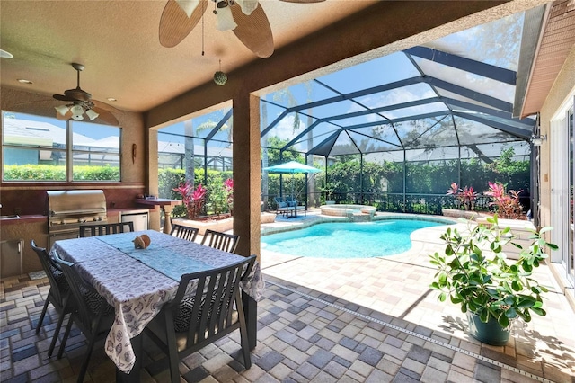 view of swimming pool with ceiling fan, a patio area, exterior kitchen, and a grill