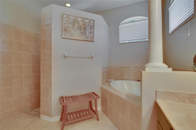full bath featuring walk in shower, vanity, tile patterned flooring, and a garden tub