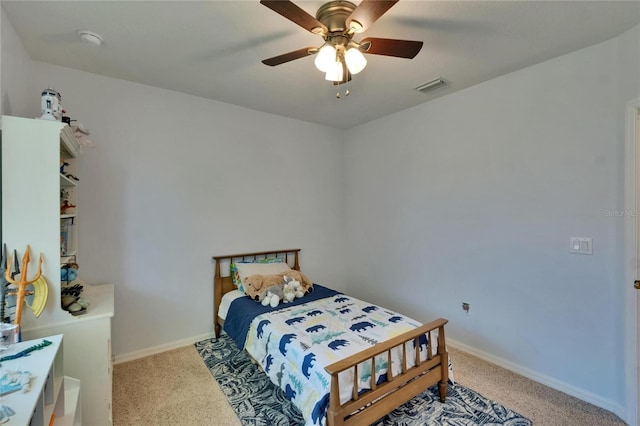 carpeted bedroom featuring baseboards, visible vents, and ceiling fan
