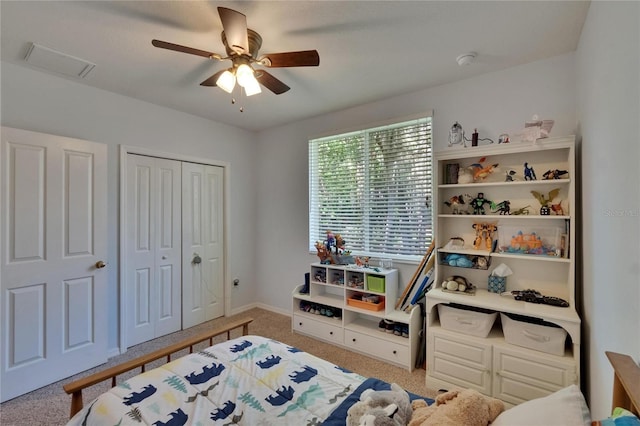 bedroom featuring ceiling fan, carpet floors, baseboards, visible vents, and a closet