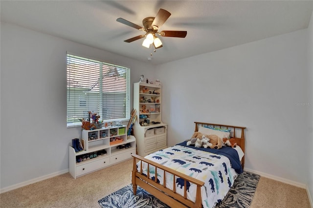 carpeted bedroom featuring baseboards and ceiling fan