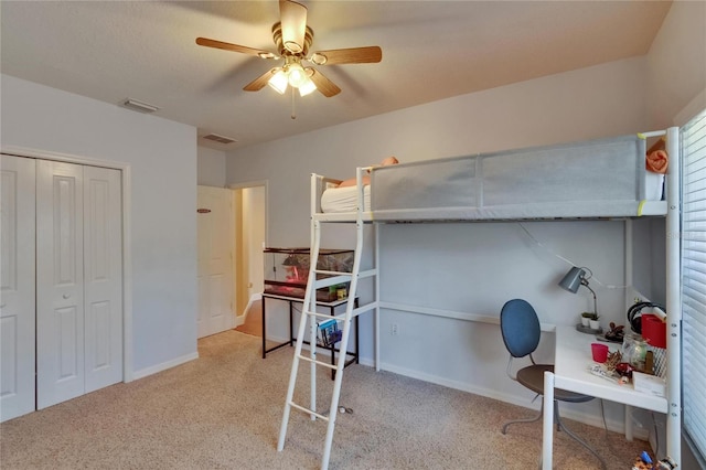 bedroom with a ceiling fan, visible vents, carpet, and a closet
