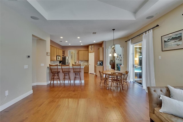 dining area with baseboards, recessed lighting, light wood-style flooring, and visible vents