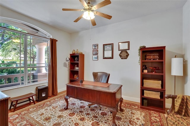 home office with baseboards and ceiling fan