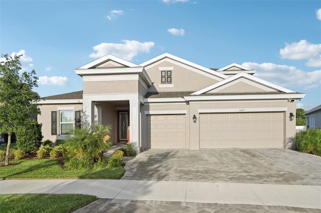 5477 Wayfarer Ave, Apollo Beach, FL 33572 - view of front of property with stucco siding, decorative driveway, and a garage