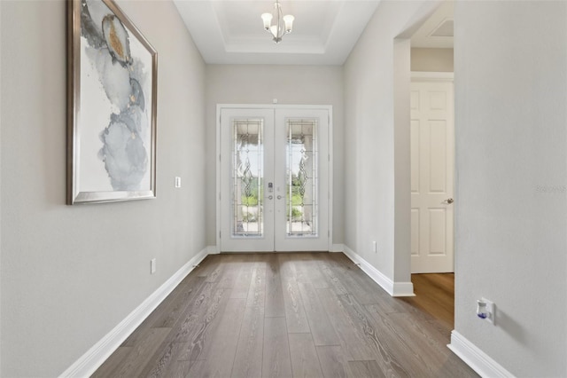 5477 Wayfarer Ave, Apollo Beach, FL 33572 - entryway featuring french doors, dark wood-style flooring, a raised ceiling, and baseboards