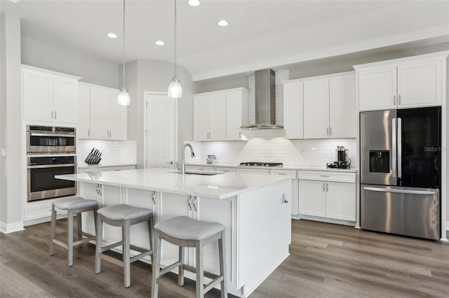 5477 Wayfarer Ave, Apollo Beach, FL 33572 - kitchen featuring stainless steel appliances, wall chimney exhaust hood, a sink, decorative backsplash, and recessed lighting