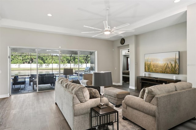 5477 Wayfarer Ave, Apollo Beach, FL 33572 - living area with wood finished floors, a ceiling fan, recessed lighting, baseboards, and crown molding