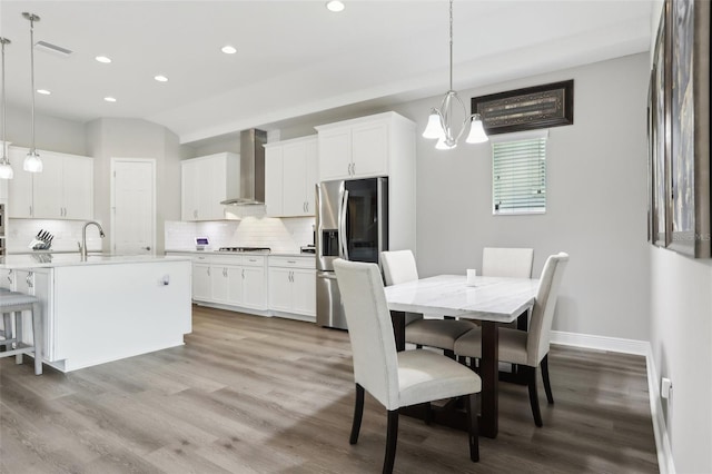 5477 Wayfarer Ave, Apollo Beach, FL 33572 - dining area with recessed lighting, light wood finished floors, baseboards, and a chandelier