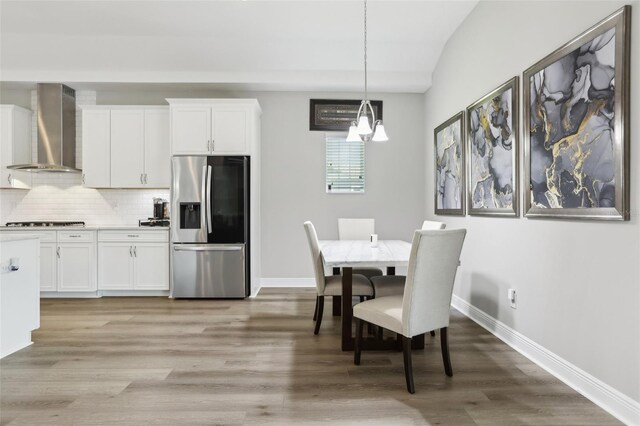 5477 Wayfarer Ave, Apollo Beach, FL 33572 - dining space featuring baseboards, light wood-style flooring, and a chandelier