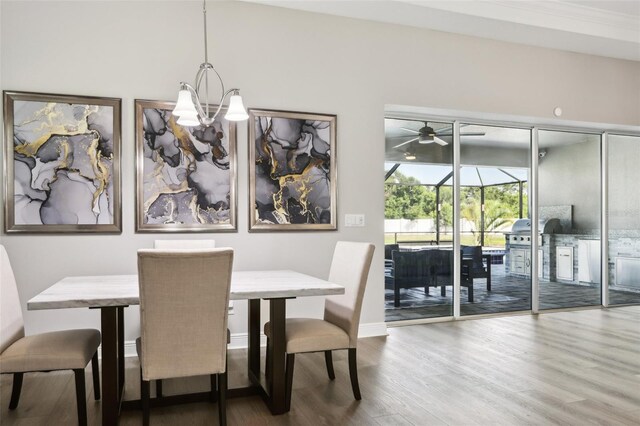 5477 Wayfarer Ave, Apollo Beach, FL 33572 - dining room with wood finished floors, a chandelier, a ceiling fan, and baseboards