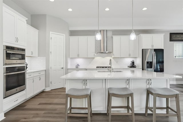 5477 Wayfarer Ave, Apollo Beach, FL 33572 - kitchen featuring stainless steel appliances, wall chimney exhaust hood, a sink, recessed lighting, and decorative backsplash