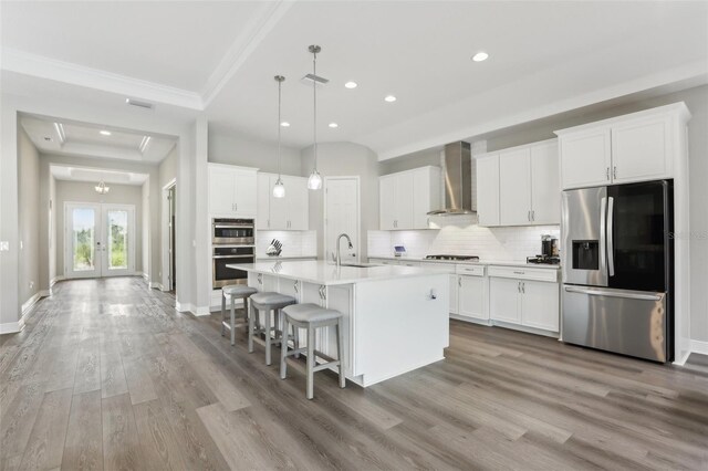 5477 Wayfarer Ave, Apollo Beach, FL 33572 - kitchen featuring appliances with stainless steel finishes, wall chimney range hood, crown molding, recessed lighting, and tasteful backsplash