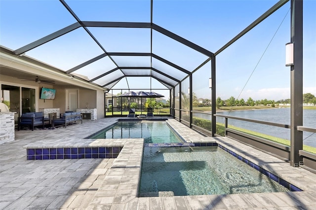 5477 Wayfarer Ave, Apollo Beach, FL 33572 - view of pool with outdoor lounge area, a patio, a water view, a ceiling fan, and a pool with connected hot tub