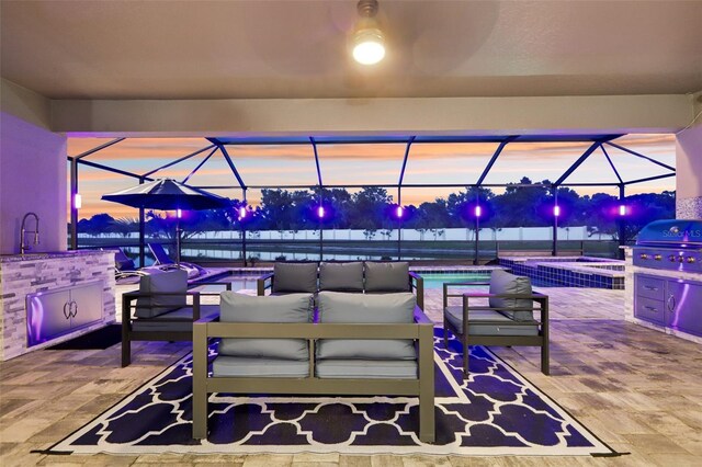 5477 Wayfarer Ave, Apollo Beach, FL 33572 - patio terrace at dusk featuring a lanai, an outdoor living space, and area for grilling