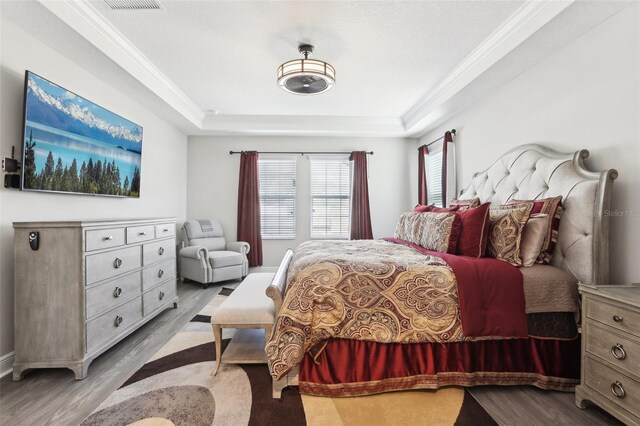 5477 Wayfarer Ave, Apollo Beach, FL 33572 - bedroom with wood finished floors, ornamental molding, and a raised ceiling