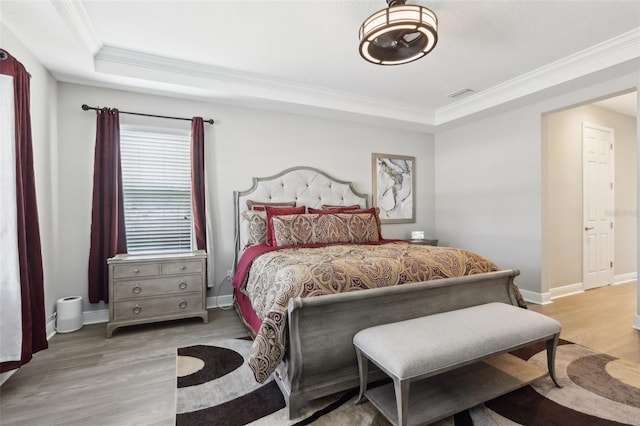 5477 Wayfarer Ave, Apollo Beach, FL 33572 - bedroom with crown molding, a raised ceiling, wood finished floors, and baseboards