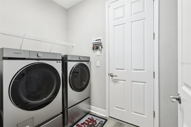 5477 Wayfarer Ave, Apollo Beach, FL 33572 - laundry room with independent washer and dryer, baseboards, and wood finished floors