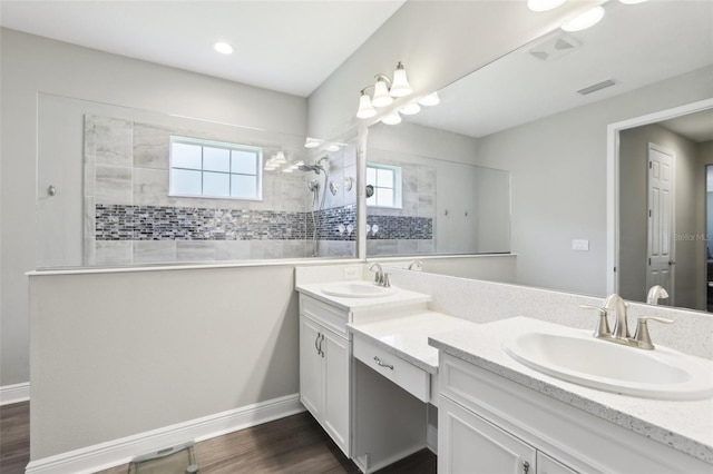5477 Wayfarer Ave, Apollo Beach, FL 33572 - bathroom featuring a walk in shower, double vanity, and wood finished floors
