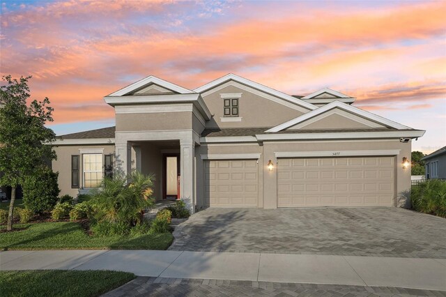 5477 Wayfarer Ave, Apollo Beach, FL 33572 - view of front of house with stucco siding, driveway, and an attached garage
