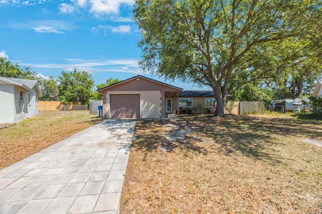 view of front of property with fence, driveway, and a front yard