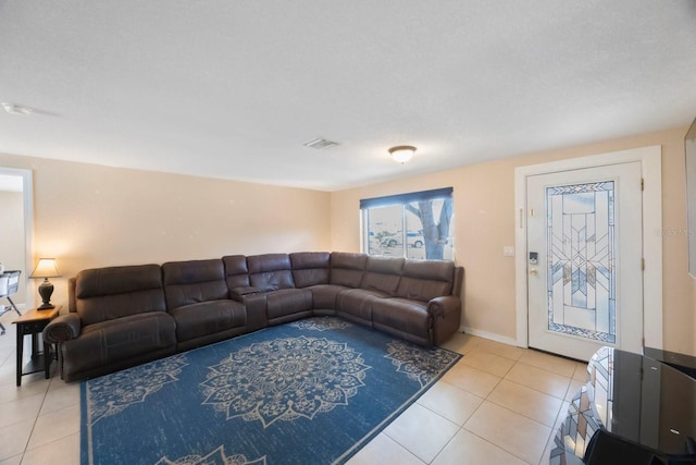 living room featuring visible vents and light tile patterned floors