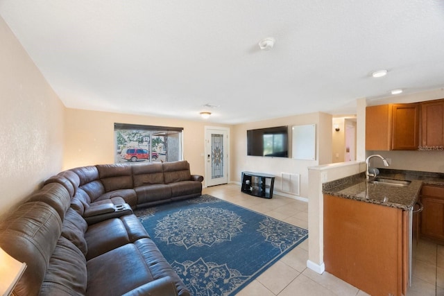 living room with light tile patterned floors, baseboards, and visible vents
