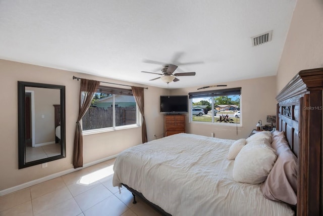 bedroom featuring baseboards, ceiling fan, light tile patterned flooring, and visible vents
