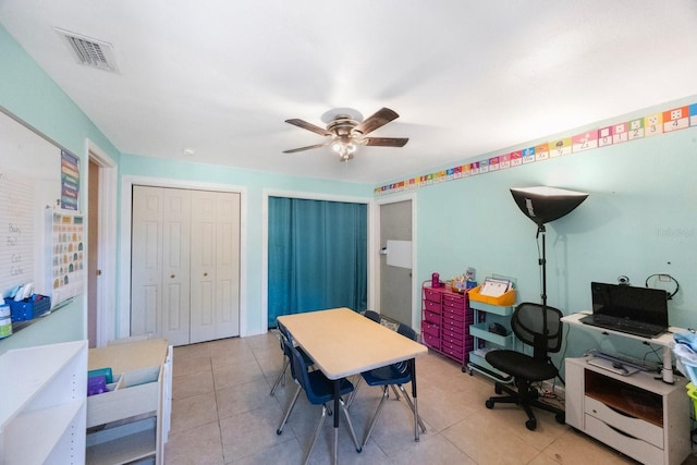 office with a ceiling fan, visible vents, and light tile patterned floors